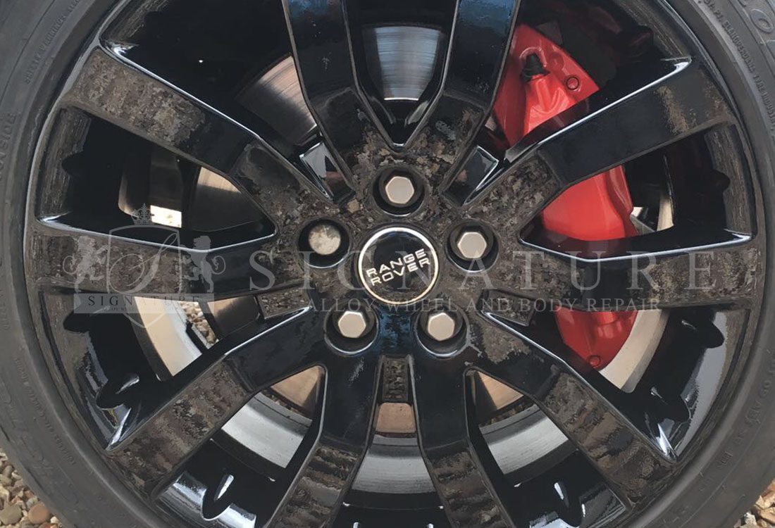Gloss black Range Rover alloy wheel refinished after kerb damage