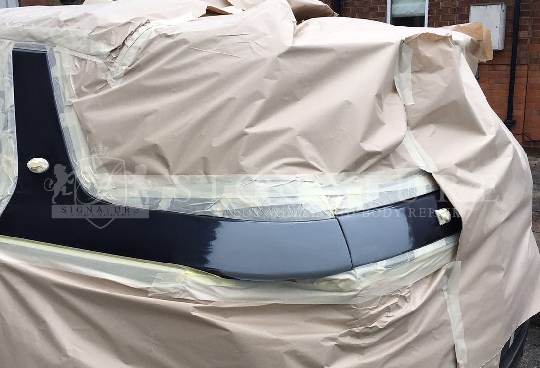 Navy blue panel masked and prepared for paint in the Radcliffe body shop