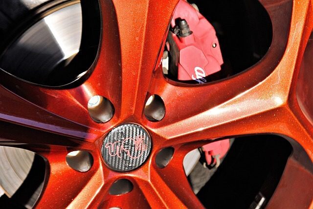 A bronze finished alloy wheel and tyre fitted to a car, photographed from the side