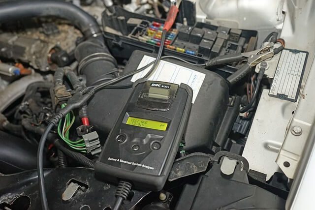 A car battery connected to diagnostic testing equipment