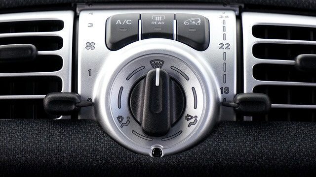 An engine bay with cooling and air conditioning components visible