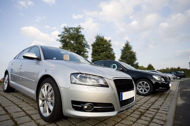 Used cars parked in rows on a dealer forecourt