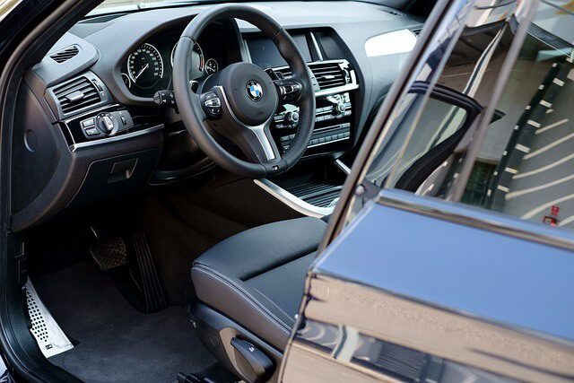 Clean interior of a car showing the front seats and floor carpets