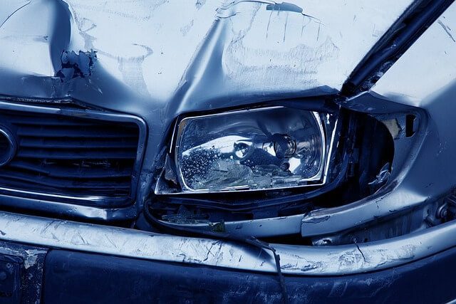 Close up of a broken headlight unit on the front corner of a car