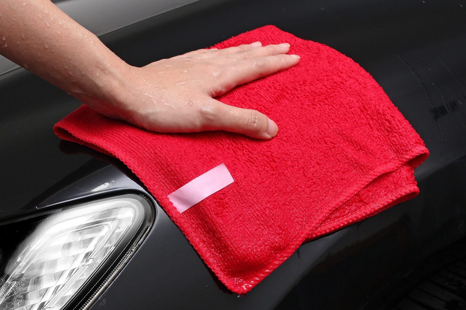 A microfibre cloth being used to work product into a smooth surface