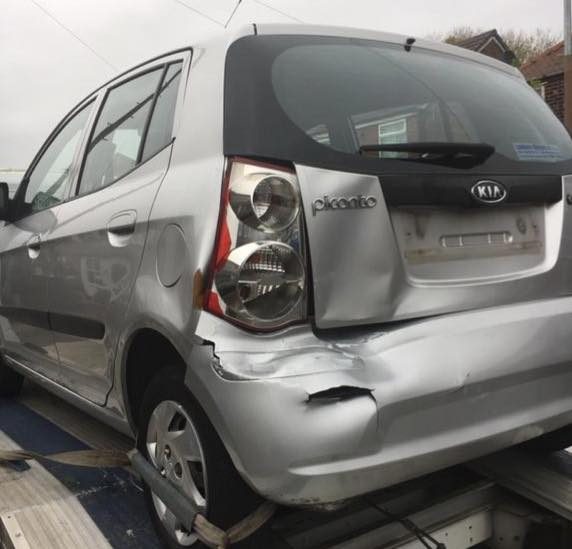 Rear quarter collision damage to a silver hatchback before repair