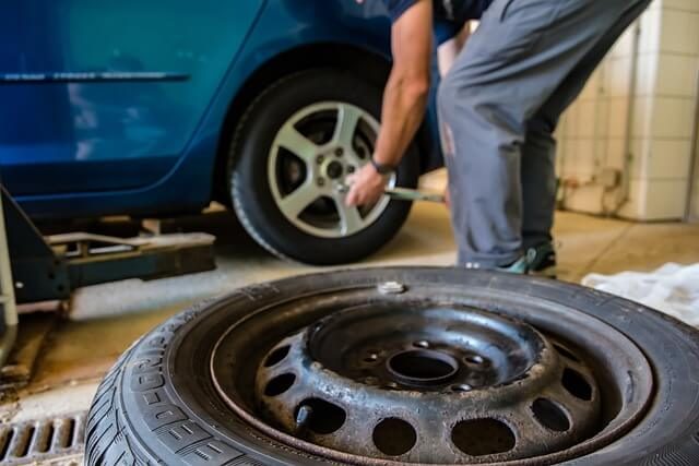 A close up of a car winter tyre with deep tread blocks